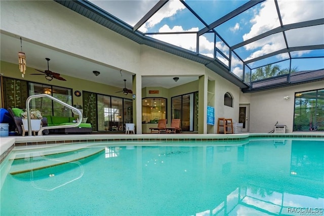 view of swimming pool featuring a lanai and ceiling fan