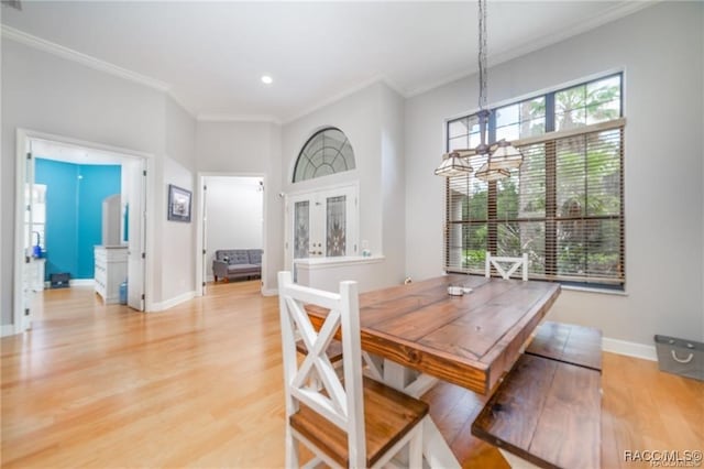 dining room with a chandelier, crown molding, and wood-type flooring