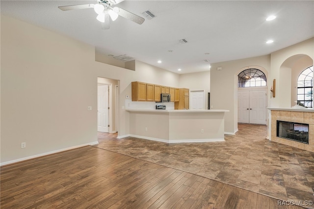 unfurnished living room featuring visible vents, recessed lighting, hardwood / wood-style flooring, and baseboards