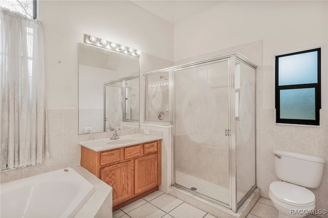 full bath featuring a stall shower, tile patterned flooring, and tile walls