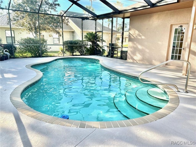 outdoor pool featuring a patio area and a lanai