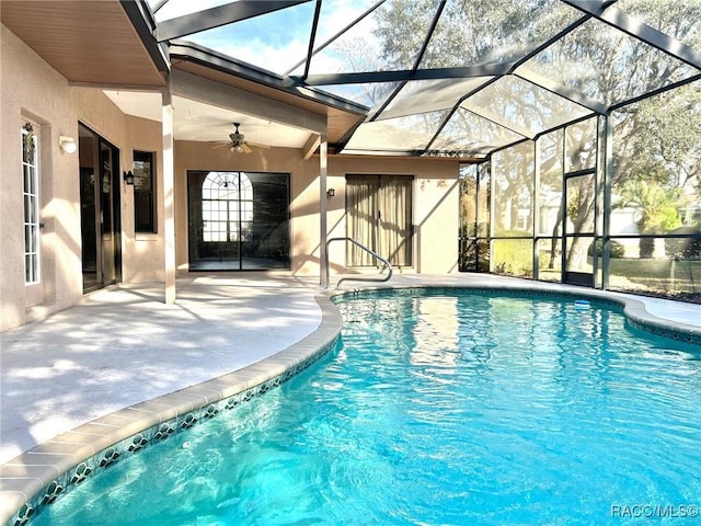 pool featuring ceiling fan, a patio, and glass enclosure