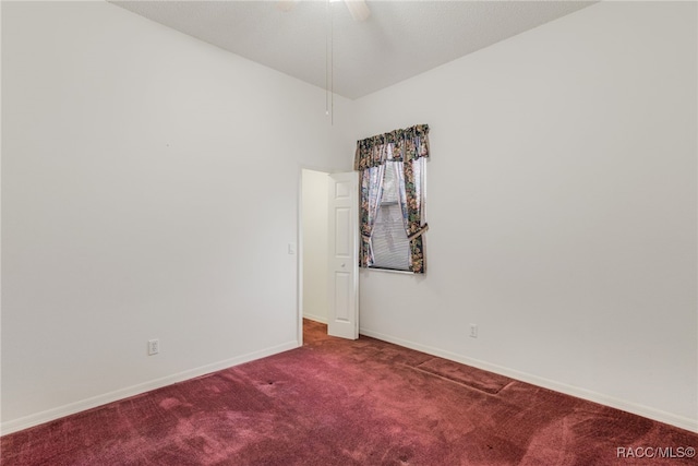 empty room featuring carpet floors, baseboards, and a ceiling fan