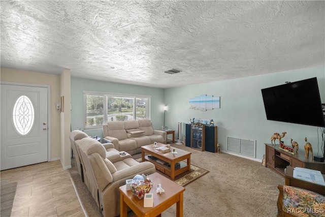 carpeted living room with a textured ceiling