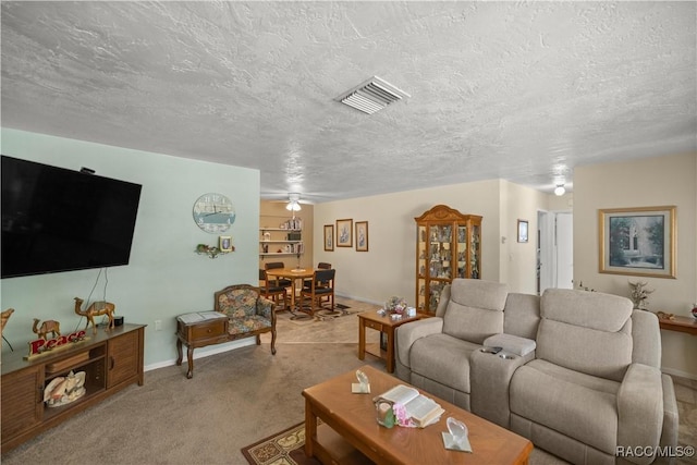 carpeted living room featuring a textured ceiling