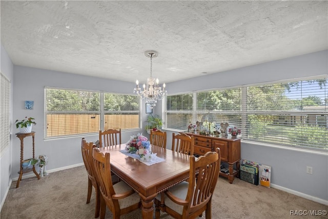 carpeted dining area with a textured ceiling, a wealth of natural light, and a chandelier