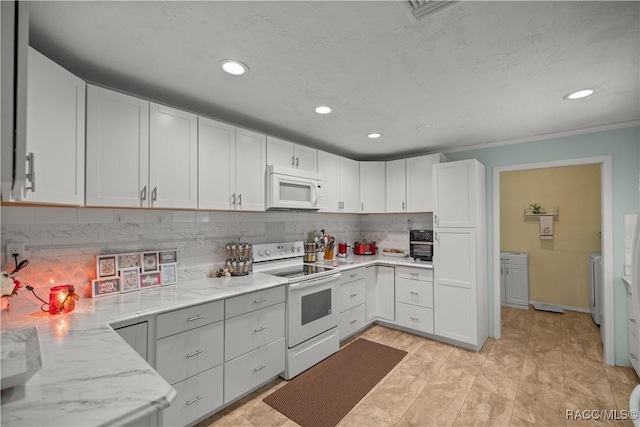 kitchen with decorative backsplash, white appliances, white cabinetry, and light stone counters