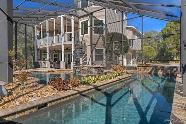 view of swimming pool with a patio area, glass enclosure, ceiling fan, and an in ground hot tub