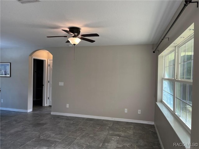 unfurnished room featuring ceiling fan