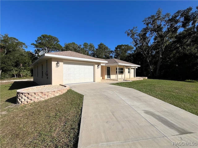 single story home with a garage and a front lawn