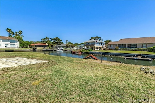 view of yard featuring a residential view and a water view