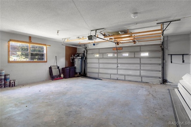 garage with water heater and a garage door opener