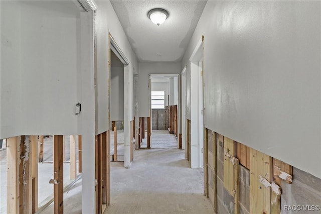 corridor featuring unfinished concrete flooring