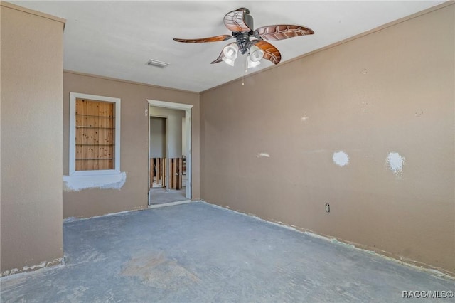 spare room with a ceiling fan, unfinished concrete floors, and visible vents