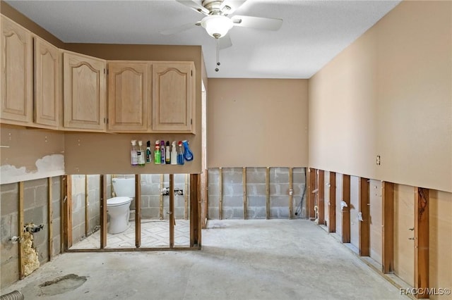 interior space with ceiling fan