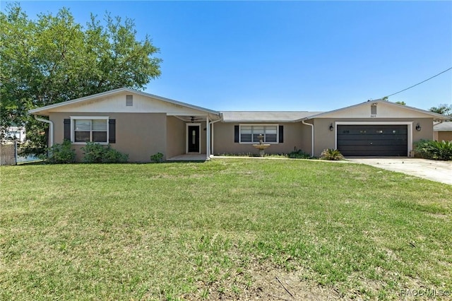ranch-style home with a front yard, a garage, stucco siding, and concrete driveway