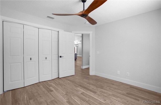 5079 W Pinto Loop, Beverly Hills, FL 34465 - unfurnished bedroom with baseboards, a closet, light wood-style flooring, and ceiling fan