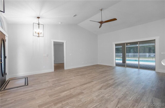5079 W Pinto Loop, Beverly Hills, FL 34465 - unfurnished living room featuring ceiling fan, light wood-style floors, a chandelier, vaulted ceiling, and baseboards