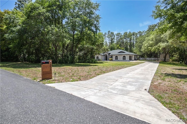 5079 W Pinto Loop, Beverly Hills, FL 34465 - view of front facade featuring concrete driveway and view of scattered trees