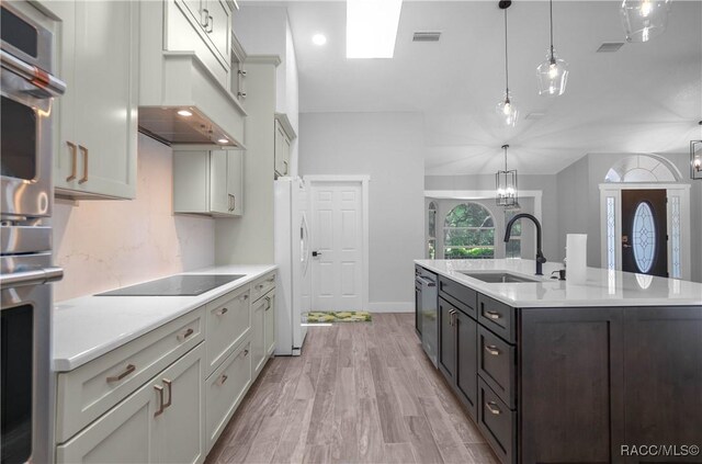 5079 W Pinto Loop, Beverly Hills, FL 34465 - kitchen featuring a sink, stainless steel appliances, light countertops, and an island with sink