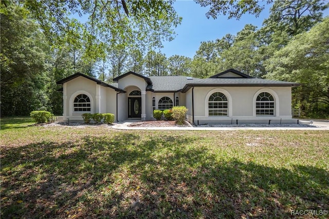 5079 W Pinto Loop, Beverly Hills, FL 34465 - view of front of house featuring a front yard and stucco siding