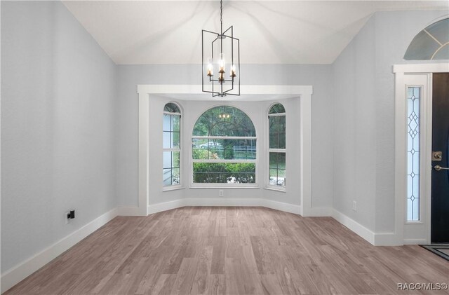 5079 W Pinto Loop, Beverly Hills, FL 34465 - entryway with a chandelier, vaulted ceiling, wood finished floors, and baseboards