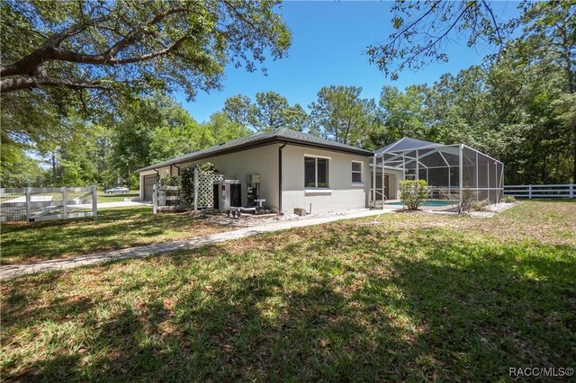 5079 W Pinto Loop, Beverly Hills, FL 34465 - back of house featuring stucco siding and a lanai