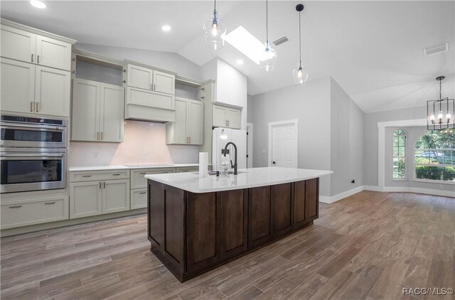5079 W Pinto Loop, Beverly Hills, FL 34465 - kitchen featuring vaulted ceiling, double oven, light countertops, black electric stovetop, and pendant lighting