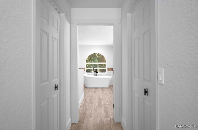 5079 W Pinto Loop, Beverly Hills, FL 34465 - corridor featuring a textured wall and wood finished floors