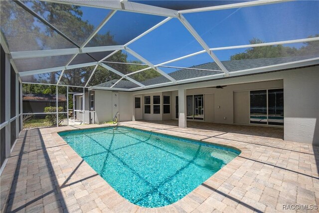 5079 W Pinto Loop, Beverly Hills, FL 34465 - swimming pool with a patio area and glass enclosure