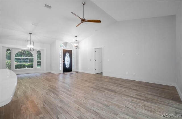 5079 W Pinto Loop, Beverly Hills, FL 34465 - unfurnished living room featuring a chandelier, a ceiling fan, light wood-style floors, baseboards, and high vaulted ceiling