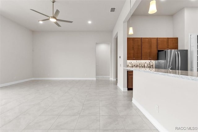 2071 N Buttonwood Loop, Hernando, FL 34442 - kitchen featuring freestanding refrigerator, a ceiling fan, brown cabinetry, light tile patterned floors, and recessed lighting