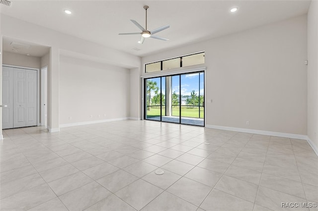 empty room with light tile patterned floors and ceiling fan