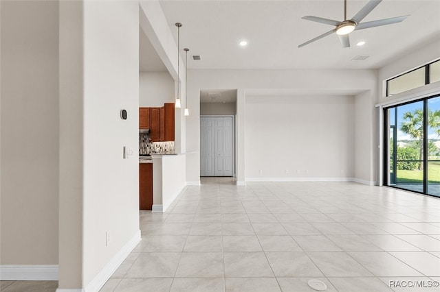 empty room with ceiling fan and light tile patterned flooring