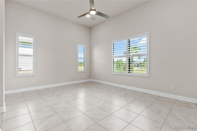 tiled spare room featuring ceiling fan