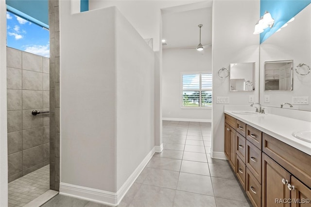 bathroom with a tile shower, vanity, tile patterned floors, and ceiling fan