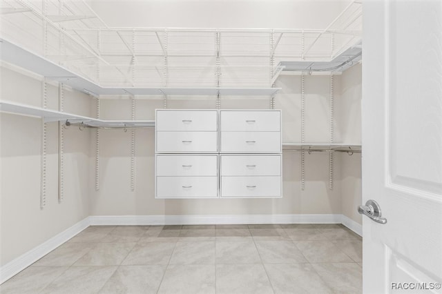 spacious closet with light tile patterned floors