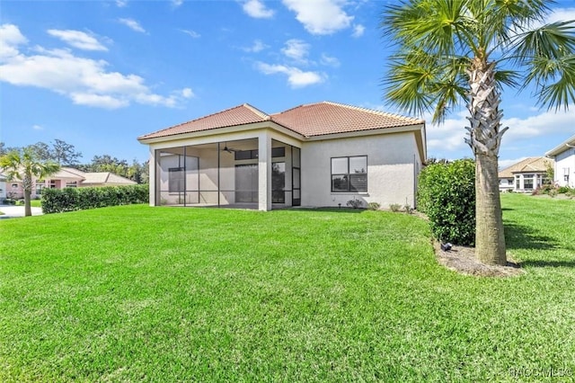 2071 N Buttonwood Loop, Hernando, FL 34442 - back of house featuring a sunroom, stucco siding, a tile roof, a yard, and ceiling fan
