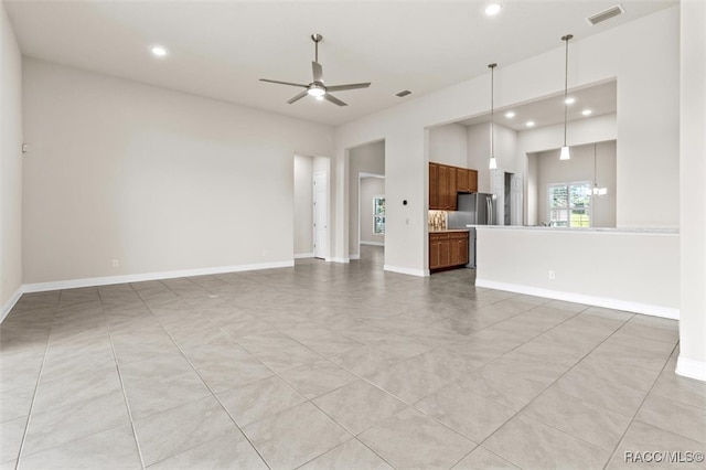 unfurnished living room featuring ceiling fan and light tile patterned flooring