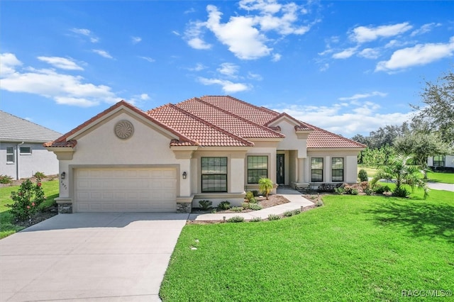 mediterranean / spanish house with a front yard and a garage