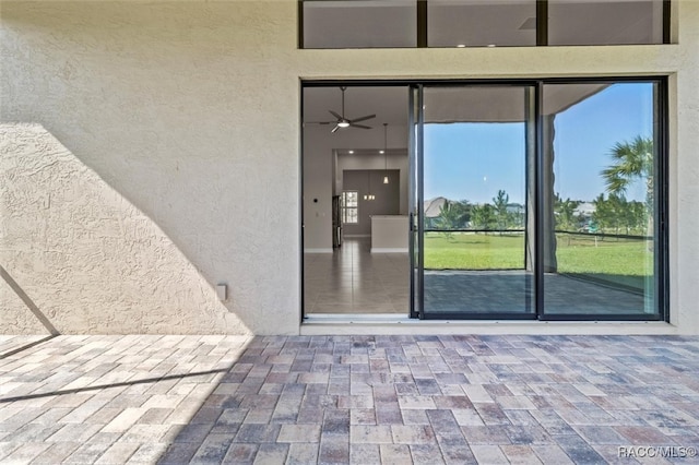 view of exterior entry with a patio