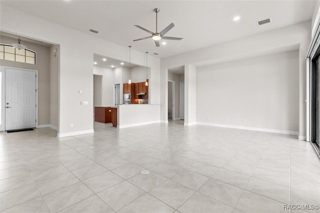 unfurnished living room with ceiling fan and light tile patterned flooring