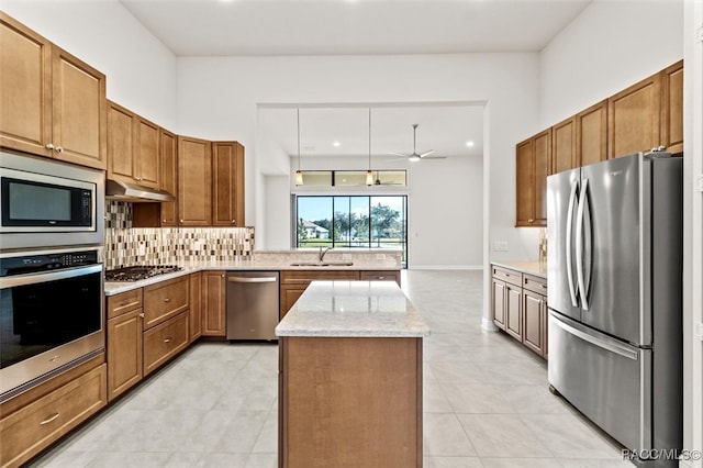 kitchen featuring decorative backsplash, appliances with stainless steel finishes, ceiling fan, sink, and light tile patterned floors