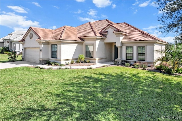 mediterranean / spanish-style house featuring a front lawn and a garage