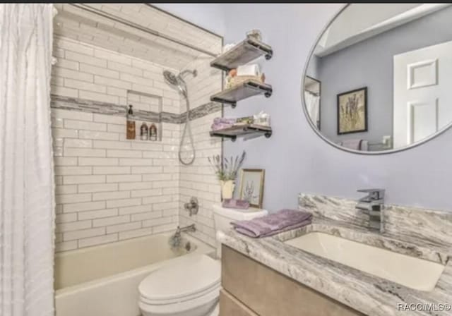 bathroom with shower / tub combo with curtain, toilet, and vanity