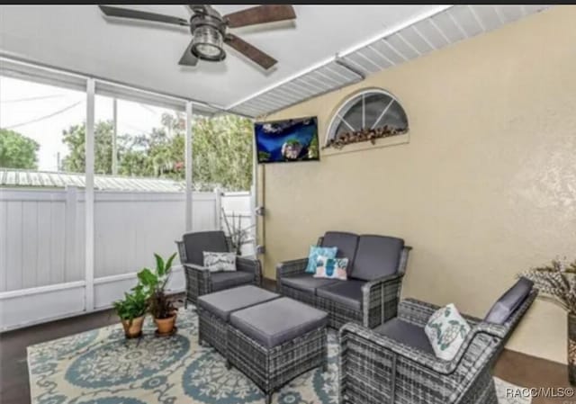 sunroom featuring vaulted ceiling and a ceiling fan