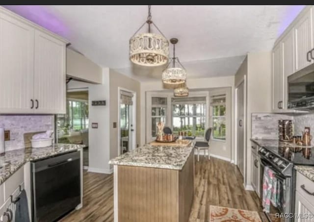 kitchen with plenty of natural light, backsplash, black appliances, and wood finished floors