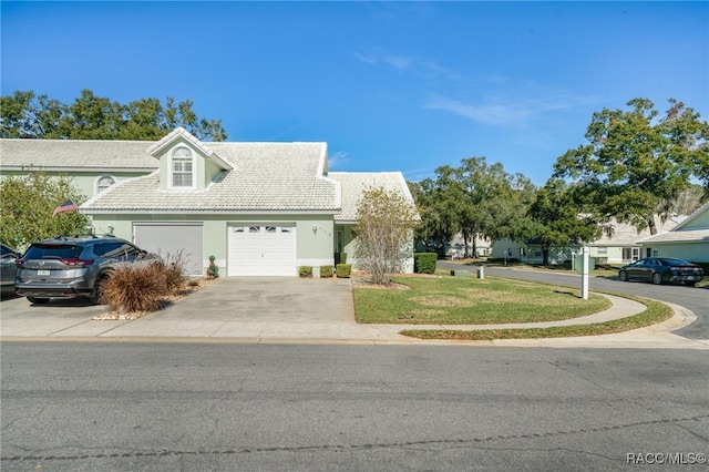 view of front of home with a front lawn and a garage