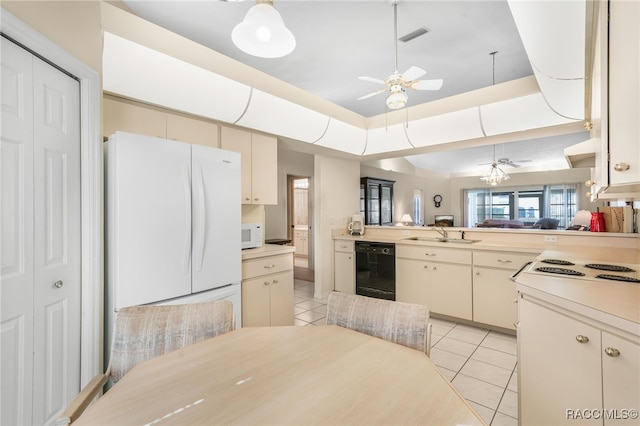 kitchen with white appliances, a raised ceiling, ceiling fan, light tile patterned floors, and cream cabinets