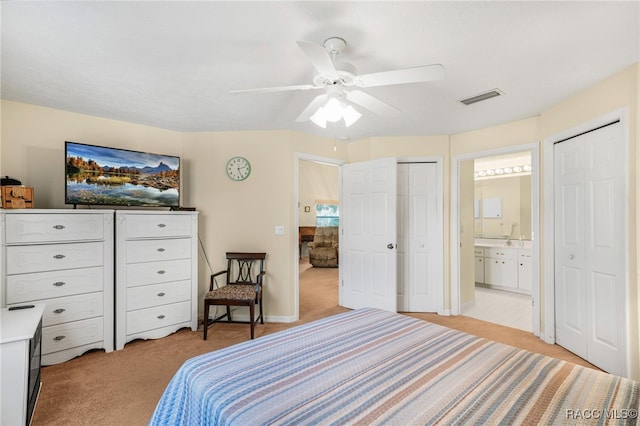 bedroom with connected bathroom, ceiling fan, and light colored carpet